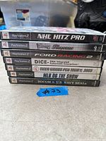 Spine view of seven PS2 game cases listed in lot