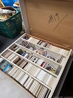 Top view of four-row storage box filled with assorted sports trading cards