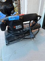 Overall view of Black & Decker corded finishing sander showing body, cord and sanding pad