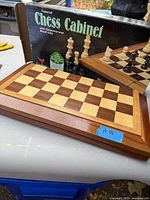 Board on table with inlaid squares and border, box in background