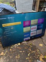 Front view of Hisense 55" Roku TV displaying home screen