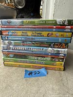 Stack of 8 cased kids DVDs with titles visible