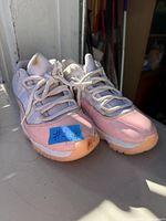 Front and side view of both shoes showing uppers, laces, and wear on toe