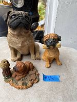 Three dog figurines displayed together