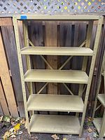 Full view of beige metal shelving unit with five shelves