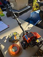 Full view of Remington Rustler trimmer with both packs of trimmer line