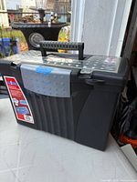 Front and side view of Storex portable file box showing handle and lid