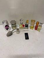 Group shot of nine assorted perfume bottles and atomizers