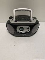 Front view showing speakers, control panel, and handle