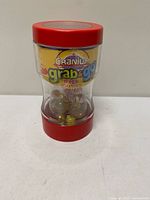 Front view of sealed Cranium Grab & Go Mega Marbles game showing contents