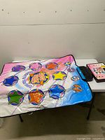 Dance mat folded on table showing star targets