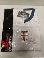 Front of sealed package showing full jersey, brand logo