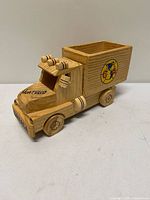 Left-side view of wooden dump truck showing Club América decal and overall construction