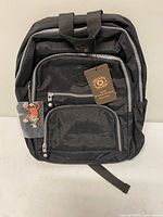 Front view showing backpack, tag, compartments