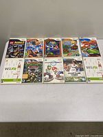 All ten Wii game cases laid out on table