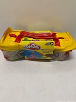 Top view of sealed Play-Doh Animal Duffel Bag showing label and handles