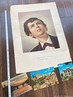 Poster with measuring tape and three postcards displayed