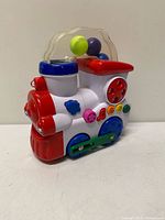 Right side view of colorful WinFun train showing buttons, gear linkage, clear dome with balls