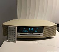 Front view of Bose Wave Music System with remote showing display on