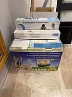 Three boxed HVAC accessories stacked: humidifier, UVC purifier, replacement lamp