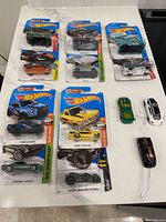 Overview of all thirteen cars showing nine sealed blister packs and four loose cars