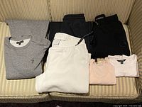 All six folded garments displayed on sofa