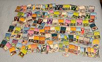 Wide view of entire spread of approximately 140-150 Pokémon cards on bed