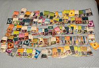 Full spread of all Pokémon cards laid out on bed showing quantity and variety