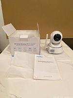 Camera, box, manual and packaging materials on tabletop