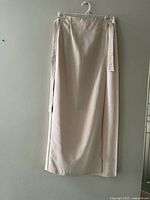 Full view of beige wrap skirt hanging