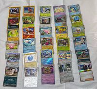 Overall view of approximately 39 Pokémon TCG cards laid out in three columns