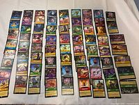 Wide shot of all Disney Lorcana cards laid out in seven columns
