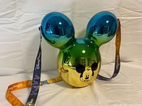 Front view showing blue ears, green midsection, gold face area, Mickey face graphic, strap colors
