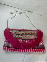 Front view of Express beaded pink fringe clutch with chain strap displayed