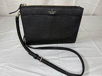 Front view of black Kate Spade crossbody bag with strap displayed