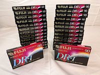 Full lot showing two stacks of Fuji DR-I tapes (60-minute on left, 90-minute on right) with one of each displayed in front