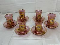 Full set of six glasses with six saucers displayed