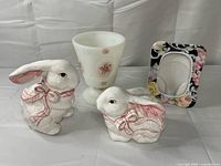 Group view: two ceramic bunnies, milk glass candle holder, floral photo frame