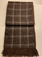 Full view of folded brown and cream plaid alpaca scarf