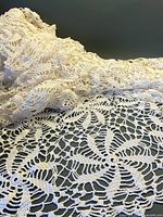 Overall view of folded crocheted tablecloth showing pattern