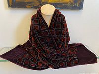 Scarf draped on display bust showing overall design and border