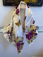 Full view of scarf draped to show size, pattern and tag