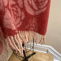 close-up of coral side rose pattern and fringe