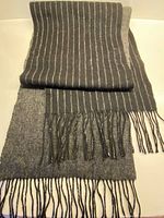 Full view of scarf showing striped side and fringe