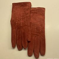 Front view of coral suede gloves pair