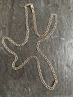 Full view of the sterling silver anchor chain necklace laid out
