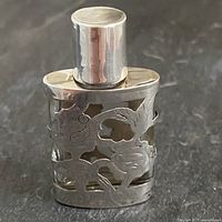 Full view of sterling overlay glass bottle with screw cap