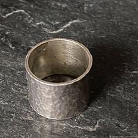 Wide hammered sterling silver band ring upright
