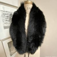 Full view of black fur scarf on mannequin