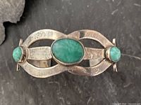 Top view showing entire sterling cuff and three turquoise stones